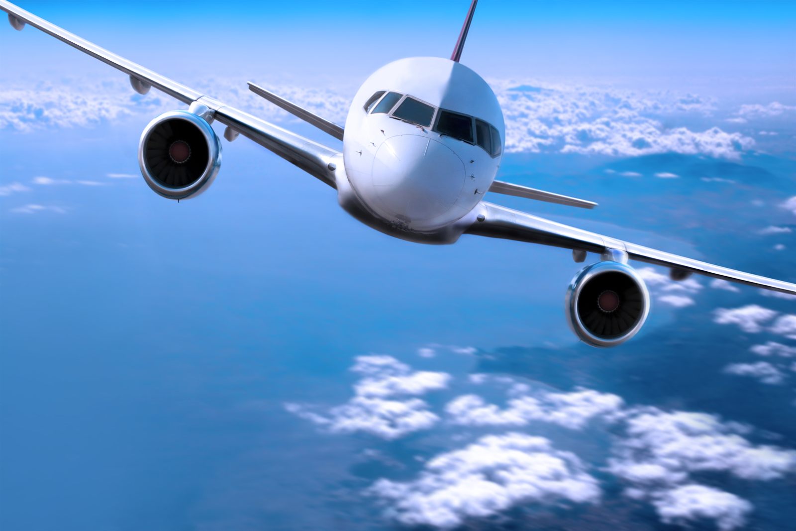 Airliner flying high in a deep blue sky