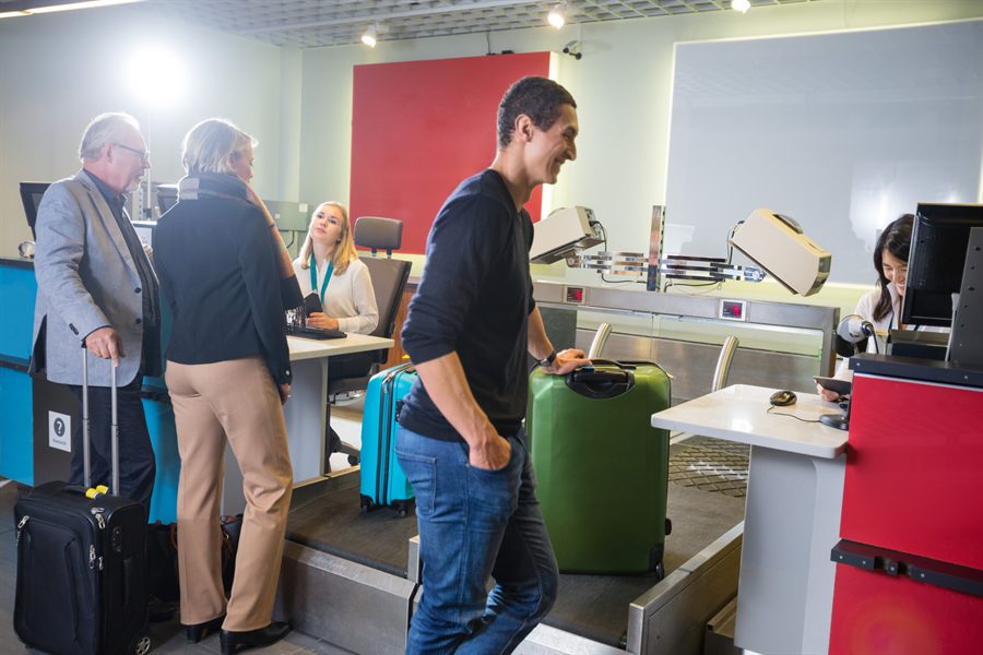 Travelers with suitcases at a check-in counter